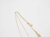 a gold necklace with a heart pendant and a gold chain on a white background
