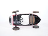 a toy car that is sitting on wheels on a white surface