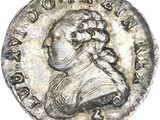 a silver coin with a portrait of a man on it