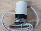 a white cord connected to a white device on a wooden surface