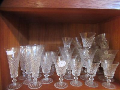 a wooden shelf with a bunch of wine glasses on it