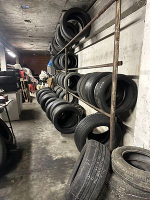 a lot of tires on a shelf in a garage