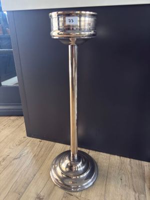 a silver plate on top of a metal stand