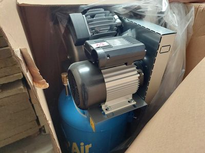 a box with a blue air compressor in it