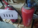 a red fire extinguisor sitting on a pallet next to a sign that says 11 11