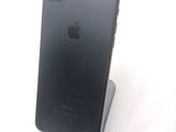 a black iphone that is sitting on top of a stand