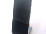 a cell phone that is on a stand on a table