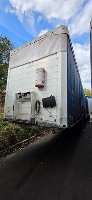 two semi trucks that are parked on the side of the road