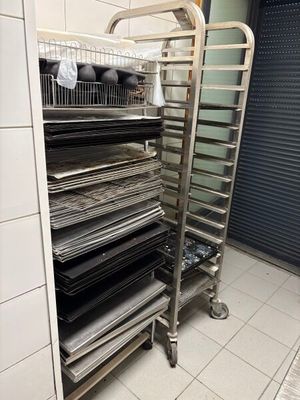 a metal rack that has many trays of food on it