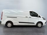 the white van is parked on the concrete floor in the room