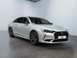 a silver car in a white room with a black floor