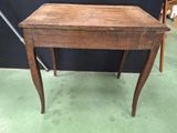 a small wooden table with a drawer on it