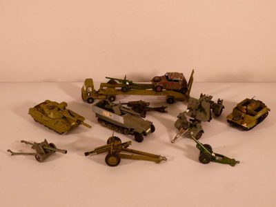 a lot of toy army vehicles on a white surface