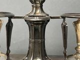 three silver vases sitting on a silver tray