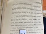 a pile of old papers with a paper tag on it