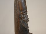 statue of a man with a beard and a hat on a wooden base