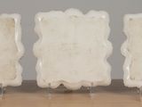 three pieces of white marble are sitting on a wooden table