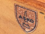 a close up of a wooden box with a sticker on it