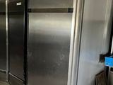 a row of refrigerators in a commercial kitchen