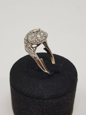 a close up of a diamond ring sitting on top of a black box