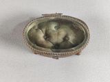 an old photo of a baby in a silver frame