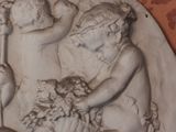 a statue of a boy and a girl with a basket of fruit