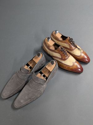 two pairs of shoes sitting on top of a table next to each other