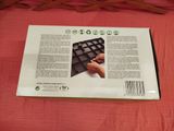 the back of a box of a keyboard on a bed