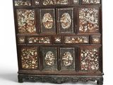 an old wooden cabinet with many drawers and carvings on it