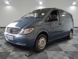 a picture of a blue van parked on a checkered floor
