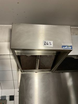 a stainless steel hood in the middle of a kitchen