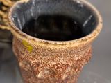 a small cup that is sitting on a table next to a spoon
