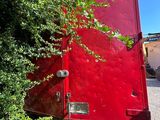 a red truck that is parked on the side of the road