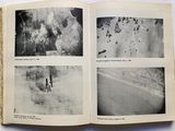 an open book with black and white photos of people walking on a beach
