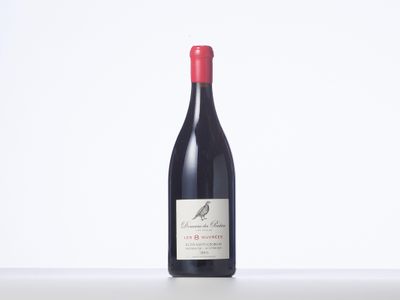 a bottle of red wine sitting on top of a table