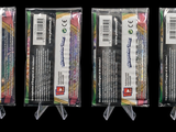 three packages of different colored pencils are lined up in a row