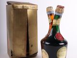 a bottle of liquor sitting next to a box
