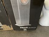 a box of speakers sitting on the floor next to a toilet