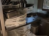 many baskets and pans on the shelves in the kitchen