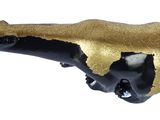 a figurine of a black and gold badger on a white background