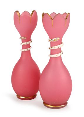 two pink vases with gold designs on them