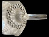 a close up of a glass vase with a flower on it