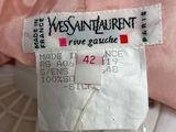 the label of a pink dress is attached to the back of the dress