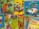 several comics are stacked on top of each other on a table