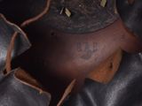 a close up view of a leather boot with a hole in it