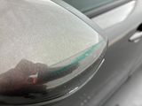 a reflection of a person in the side mirror of a car