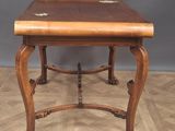 a wooden table with a drawer on top of it on a wooden floor