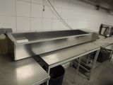 a large stainless steel sink in the middle of a kitchen