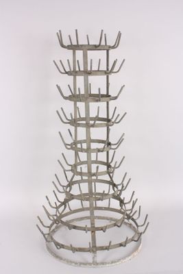 a metal wine rack that has a lot of bottles in it