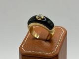 an image of a gold ring with a black stone on it